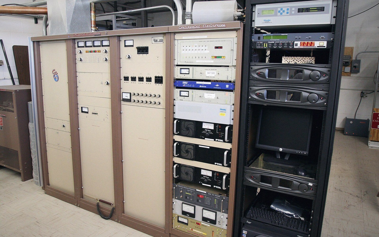 An engineer at a rack of transmitter cabinets